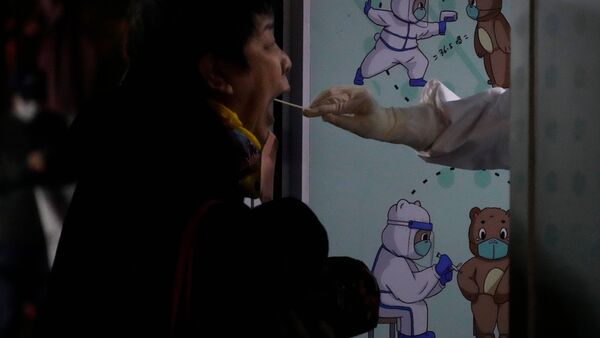 Eine Frau macht einen Corona-Test (Symbolbild). China verfolgt nach wie vor eine strenge Zero-Covid-Politik., © Ng Han Guan/AP/dpa